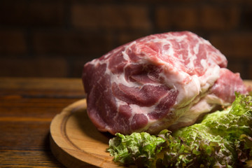Raw pork meat on wooden board.  Fresh ingredient