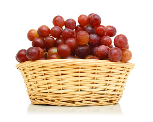 red grapes in basket on white background