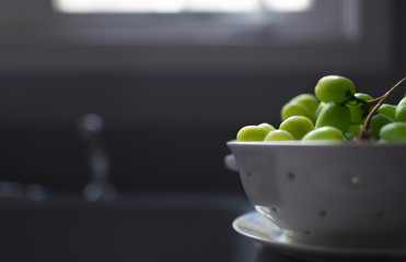 View of fresh green grapes in a white ceramic strainer