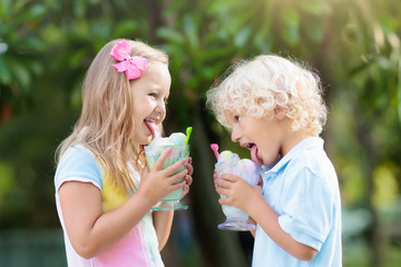 Kids eating ice cream. Child with fruit dessert.