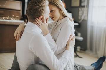 Loving couple kissing in the room