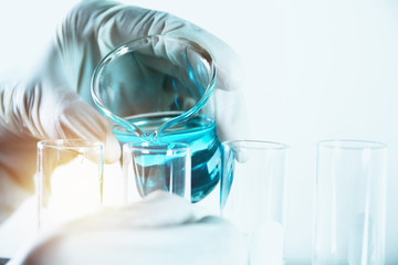 Researcher with glass laboratory chemical test tubes with liquid for analytical , medical, pharmaceutical and scientific research concept.
