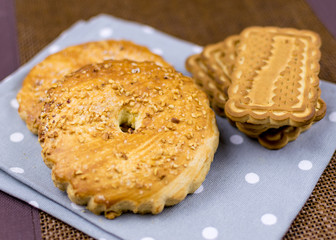Different cookies lying on the tablecloth.