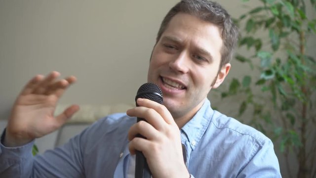 Man singing karaoke at home. Close-up view.