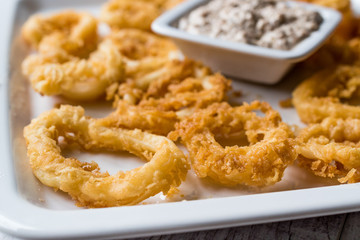 Fried Crispy Calamari Squid Rings with Tartar Sauce and Lemon.
