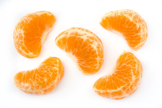 Fresh piece tangerine isolated on white background. Top view