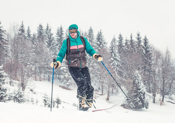 Fototapeta na wymiar Skier on mountain cross-country skiing in heavy snow 