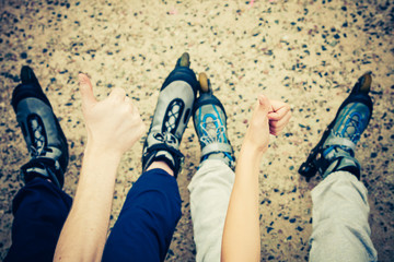 People friends with roller skates outdoor.