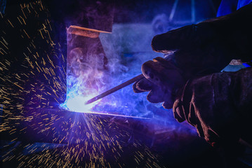 Welding steel structures and bright sparks with lens flare