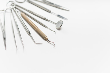 on a white background lies a sterile dental toolkit