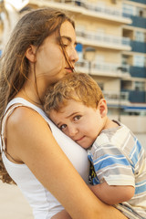 Fototapeta premium Close up sleepy little boy lean on sisters arms.