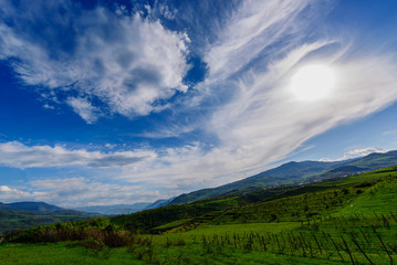 Amazing spring skyscape with beautiful clouds and green field, Armenia