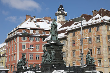 Monument of Archduke John in Graz, Austria.In the background schlossberg hill with clocktower uhrturm.Old town of Graz is the UNESCO World heritage