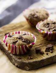 Homemade muffins with chocolate on an old wooden Board