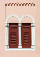 brown wood window at classic pink building