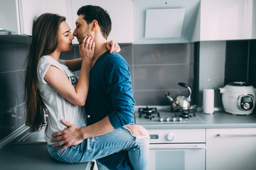 A photo session of a guy and a girl in a cozy home environment.
