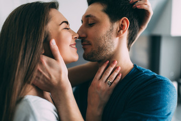 A photo session of a guy and a girl in a cozy home environment.