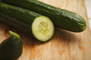 Fresh green cucumbers on cutting board closeup