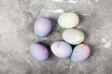 Multi-colored eggs for Easter on gray background. Top view. Food background