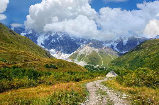 Grassy valley and snow-capped mountains in Georgia