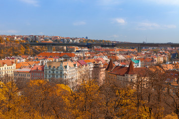 Fototapeta na wymiar Prague living blocks red rooftops with park and trees. Fall season