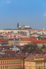 Fototapeta na wymiar Prague rooftops. Beautiful aerial view of Czech baroque architecture and St. Vitus Cathedral.