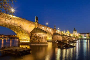 Scenic summer night view of the Charles bridge over Vltava river in Prague, Czech Republic. Illuminated beauty.