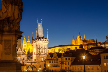 Charles Bridge and Hradcany (Prague Castle) with St. Vitus Cathedral at night, Bohemia landmark. Prague, Czech Republic.