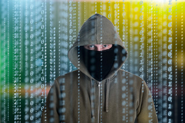Hackers programmer look on screen and writes the program code hack information and user account