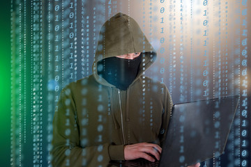 Hackers programmer look on screen and writes the program code hack information and user account