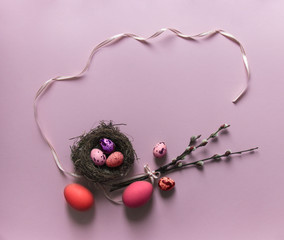 pink background willow branches blossomed eggs quail chicken nest with three red purple color view from above ribbon bow pink oval
