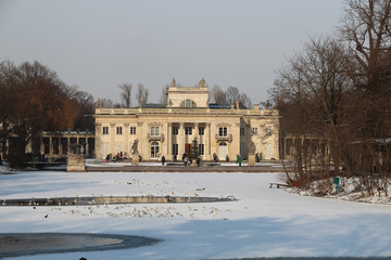 Fototapeta na wymiar Baroque building of the Palace on the Isle under the cloudy sky, Warsaw Royal Baths Park, Poland