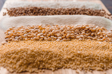 scattered groats in a row on a cutting board