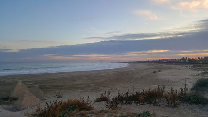 A golden sunset in the blue sea