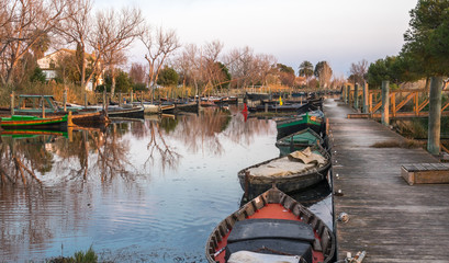 several traditional wooden boats on the mooring dock. harbor of the Albufera nature reserve, Catarroja Valencia Spain