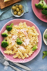 Pasta spiral with broccoli on gray background, top view. Italian food concept.