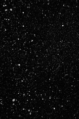 Real falling snowflakes on a black background. Can be used as a texture layer in different types of...