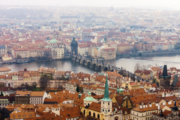Obraz premium View of Praha with Vltava river and Charles Bridge from Prague Castle on rainy day