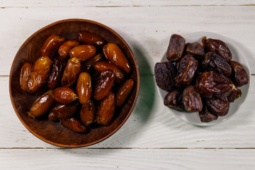 Dried dates fruit on white wooden table. Top view