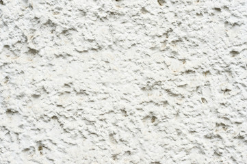 Close-up Deep texture of white-painted porous stone on the facade of the building. Stoned wall background texture