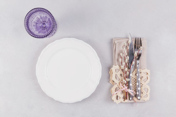  White plate, blue glass, cutlery and pussy willow