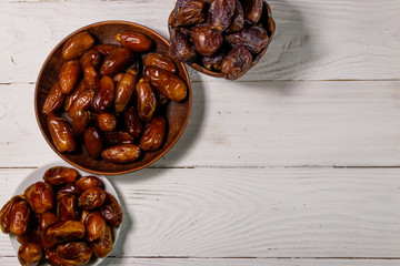 Dried dates fruit on white wooden table. Top view