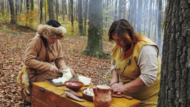 Womens viking are cooking in the forest camp