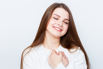 Surprised astonished lady has shocked expression, points with fore finger at copy space on ...