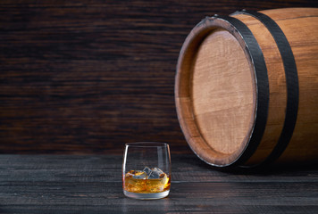 whiskey with ice  cube on a wooden table