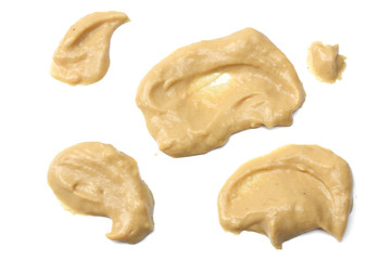 mustard splashes isolated on white background top view