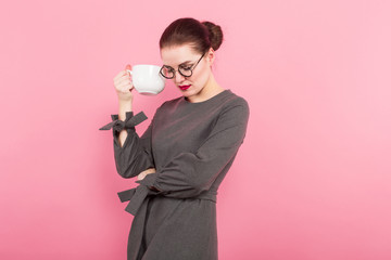 Businesswoman with hair bun and cup