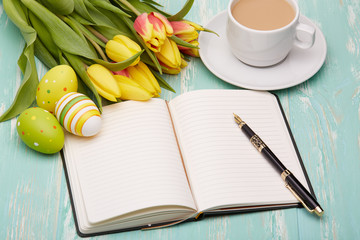 Easter eggs, blank daily log and tulips.