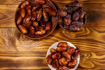 Dried dates fruit on wooden table. Top view