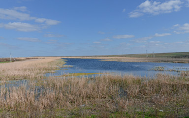 blue surface of yerik (shallow channel) Darma on sunny day in spring Astrakhan region, Russia